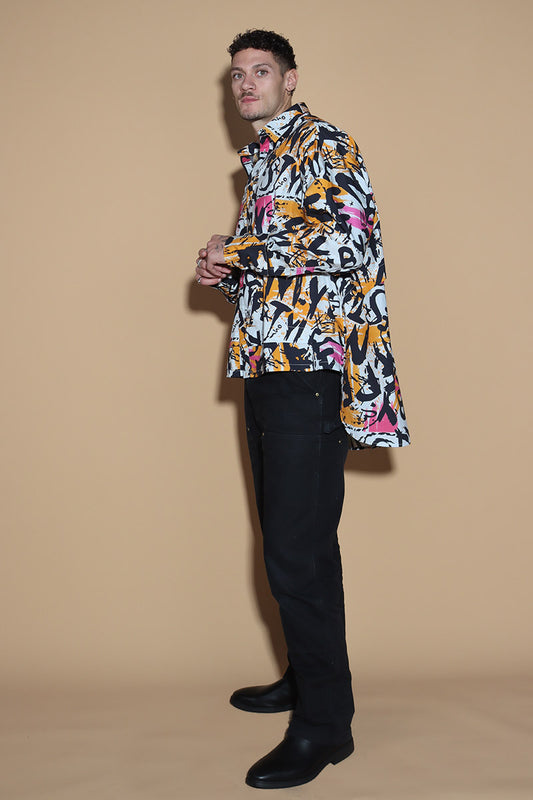 In an overall graffiti print, the oversize shirt keeps it fun in exuding a confident charm. Grunge vibe with a difference, the shirt has a shirt collar and front closure however it is the details that make it knot your average shirt. The shirt has a layered detail on the front and the back. The long sleeves come with an extra long cuff, that can be rolled up for a statement sleeve look or a sleeker cuffed up look.
