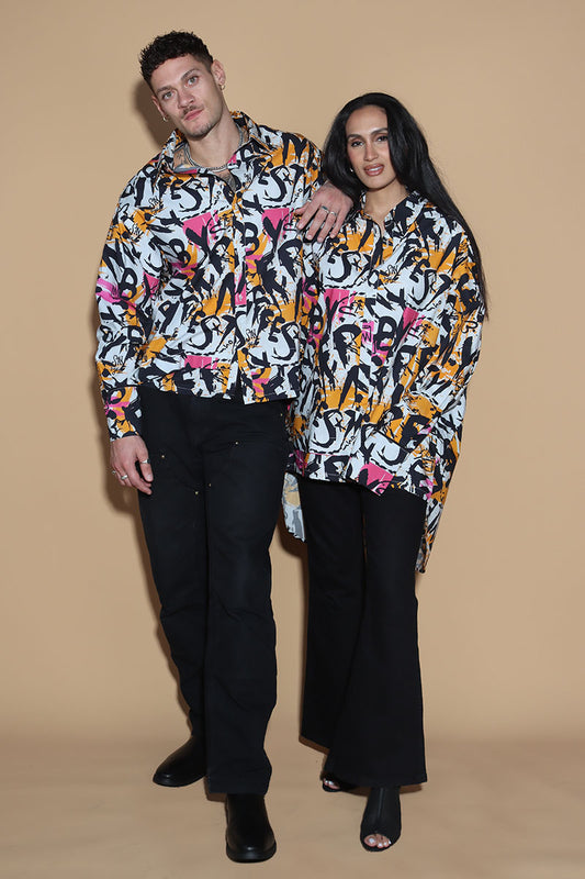 In an overall graffiti print, the oversize shirt keeps it fun in exuding a confident charm. Grunge vibe with a difference, the shirt has a shirt collar and front closure however it is the details that make it knot your average shirt. The shirt has a layered detail on the front and the back. The long sleeves come with an extra long cuff, that can be rolled up for a statement sleeve look or a sleeker cuffed up look.