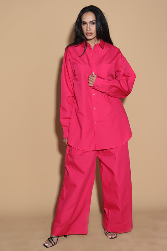 With a shirt collar and front button closure, the shirt in a luxe cotton blend is going to be your new favourite. It is accented with contrasting details showcasing your penchant for details, allowing you to make a statement in style with substance that demands a second look. The pants have an elasticated waist and a drawstring to adjust it however you like. . Embrace your inner barbie with this pink set