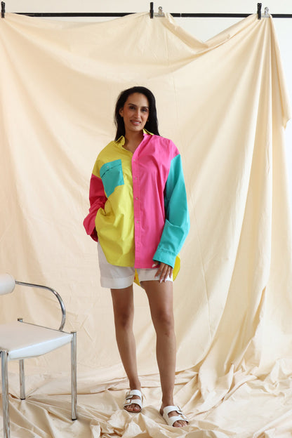 Person wearing multi coloured relaxed fit button up shirt with three colours and full sleeves in cotton with white cotton summer shorts