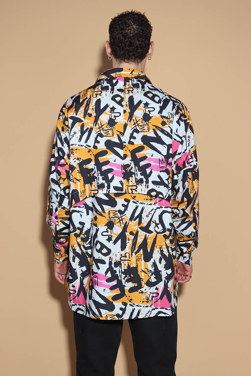 In an overall graffiti print, the oversize shirt keeps it fun in exuding a confident charm. Grunge vibe with a difference, the shirt has a shirt collar and front closure however it is the details that make it knot your average shirt. The shirt has a layered detail on the front and the back. The long sleeves come with an extra long cuff, that can be rolled up for a statement sleeve look or a sleeker cuffed up look.