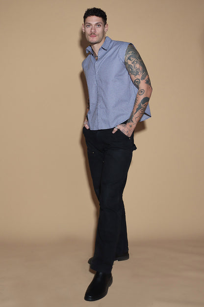 The front button down low crop shirt with a shirt collar and front button closure might seem like your run of the mill shirt. However the shirt can be styled partially sleeved or completely sleeveless with detachable sleeves that can be snapped on and off in parts or completely.  The monochrome check shirt is the perfect cropped moment that lets you style it in more ways than one. Go for the full sleeves, cold shoulder on either or both arms or completely sleeveless - the possibilities are endless.