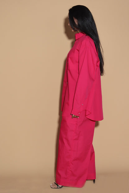 With a shirt collar and front button closure, the shirt in a luxe cotton blend is going to be your new favourite. It is accented with contrasting details showcasing your penchant for details, allowing you to make a statement in style with substance that demands a second look.  The pants have an elasticated waist and a drawstring to adjust it however you like. . Embrace your inner barbie with this pink set