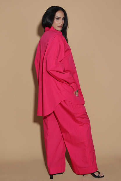 With a shirt collar and front button closure, the shirt in a luxe cotton blend is going to be your new favourite. It is accented with contrasting details showcasing your penchant for details, allowing you to make a statement in style with substance that demands a second look.  The pants have an elasticated waist and a drawstring to adjust it however you like. . Embrace your inner barbie with this pink set