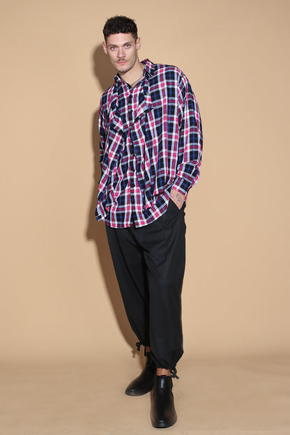 An easy shirt that sashays with your every move. The Sway Drape shirt in Cotton has an overall check in tones of purples and pinks. The shirt has a shirt collar and front button closure, with a double layer front with button and button-holes to create optional drape effect.