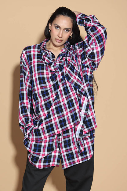 An easy shirt that sashays with your every move. The Sway Drape shirt in Cotton has an overall check in tones of purples and pinks. The shirt has a shirt collar and front button closure, with a double layer front with button and button-holes to create optional drape effect.