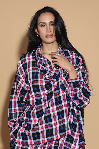 An easy shirt that sashays with your every move. The Sway Drape shirt in Cotton has an overall check in tones of purples and pinks. The shirt has a shirt collar and front button closure, with a double layer front with button and button-holes to create optional drape effect.