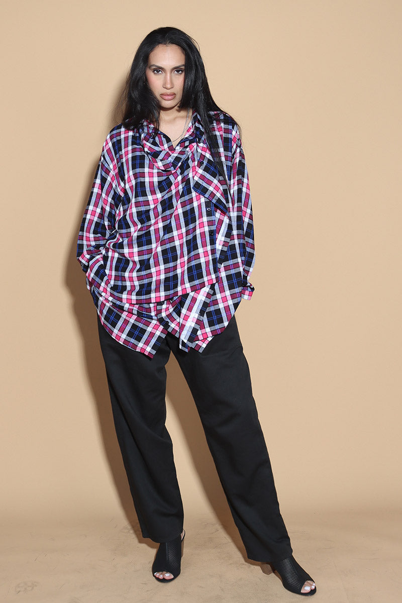 An easy shirt that sashays with your every move. The Sway Drape shirt in Cotton has an overall check in tones of purples and pinks. The shirt has a shirt collar and front button closure, with a double layer front with button and button-holes to create optional drape effect.