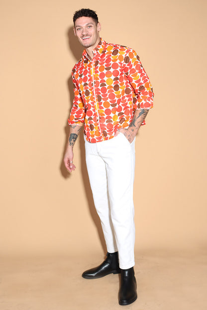 Exude a fun retro vibe of the sixties and seventies that makes for a fun look in this shirt. In warm tones of reds, oranges and yellows, the overall circle print shirt has a shirt collar and front button closure with full sleeves. Trimmed and complimented with white details that finish off the look giving it just the polished look needed. Style this fun retro shirt with white pants or denims or white shorts.
