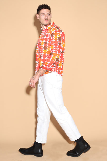 Exude a fun retro vibe of the sixties and seventies that makes for a fun look in this shirt. In warm tones of reds, oranges and yellows, the overall circle print shirt has a shirt collar and front button closure with full sleeves. Trimmed and complimented with white details that finish off the look giving it just the polished look needed. Style this fun retro shirt with white pants or denims or white shorts.