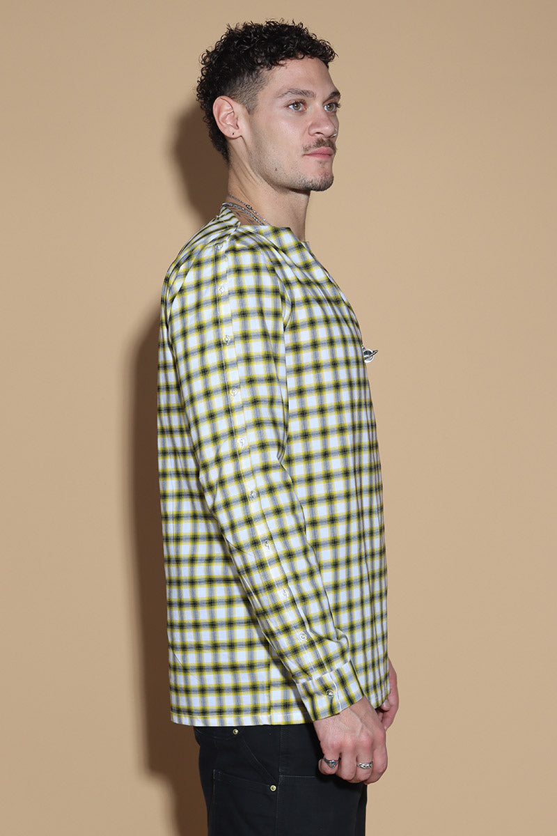Add a little punk 70s element to your look with this check shirt that is all sorts of fabulous. In yellow, blacks and white check, The shirt has a sleeve and shoulder button through closure. Giving you styling options between opting for a boat neck opening or open up the buttons for a cowl neck it can be styled what suits your style. The sleeve buttons can be opened up too, to style it as a full sleeve top, or get your arms out at any length you like.