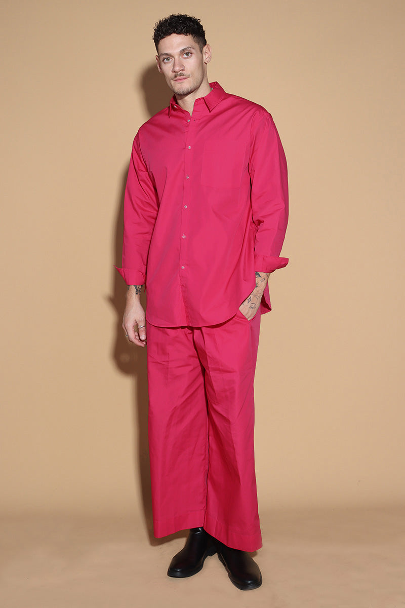 With a shirt collar and front button closure, the shirt in a luxe cotton blend is going to be your new favourite. It is accented with contrasting details showcasing your penchant for details, allowing you to make a statement in style with substance that demands a second look.  The pants have an elasticated waist and a drawstring to adjust it however you like. . Embrace your inner barbie with this pink set
