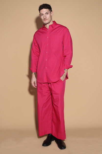 With a shirt collar and front button closure, the shirt in a luxe cotton blend is going to be your new favourite. It is accented with contrasting details showcasing your penchant for details, allowing you to make a statement in style with substance that demands a second look.  The pants have an elasticated waist and a drawstring to adjust it however you like. . Embrace your inner barbie with this pink set