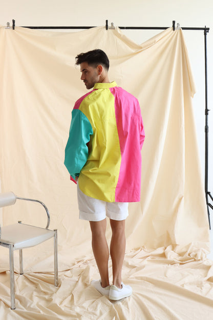 Person wearing multi coloured relaxed fit button up shirt with three colours and full sleeves in cotton with white cotton summer shorts