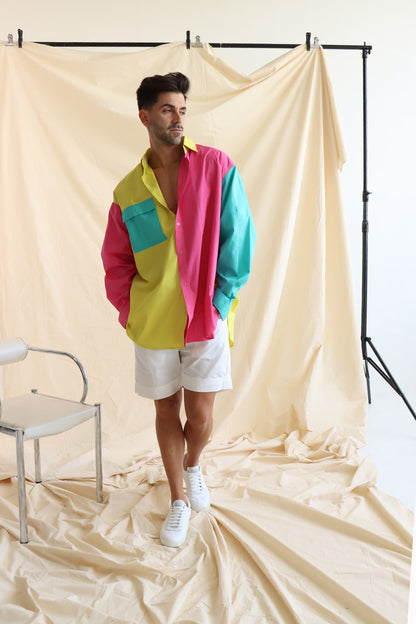 Person wearing multi coloured relaxed fit button up shirt with three colours and full sleeves in cotton with white cotton summer shorts