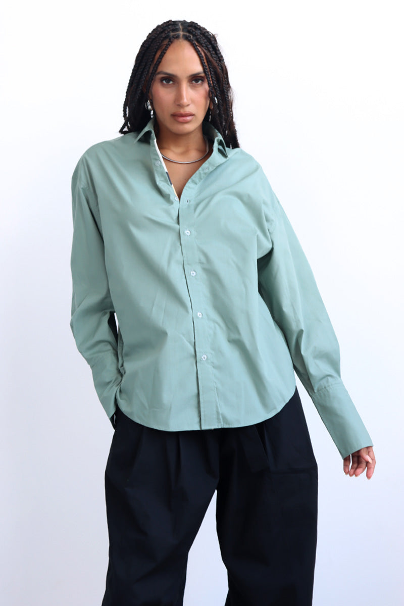 green shirt with printed trims and extra long cuff in a cropped shirt with button down and collar