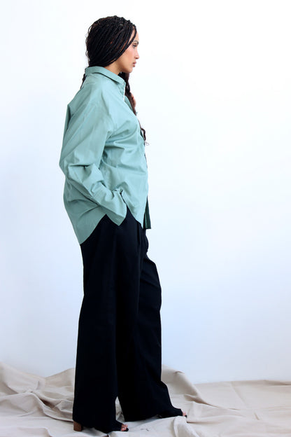 green shirt with printed trims and extra long cuff in a cropped shirt with button down and collar