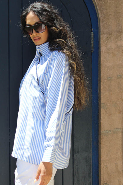 Being in Business never looked this hot. This Benny shirt combines business and party all in one look, perfect for the season. The cotton shirt in blue stripes features a shirt collar and front button closure. Keeping it easy, the shirt has a relaxed silhouette and raglan dolman sleeves to keep it cool and breezy during the hotter season. With Navy trims giving it extra detail, Be it a business brunch or after work drinks, the shirt keeps your style in check.