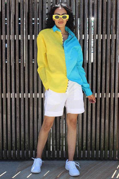 The easy summer shirt that is striking as it is bold in its approach. The oversized 90s referenced Cyrus Shirt is a two toned shirt in Cotton with a shirt collar and cuffed sleeves. In bright tones perfect for a sunny side day, the shirt has black and white trims that give it an extra edge and detail that you might not find somewhere else. Devil surely is in the details. A front button down and style it with Bliss shorts or pants for an easy statement look.