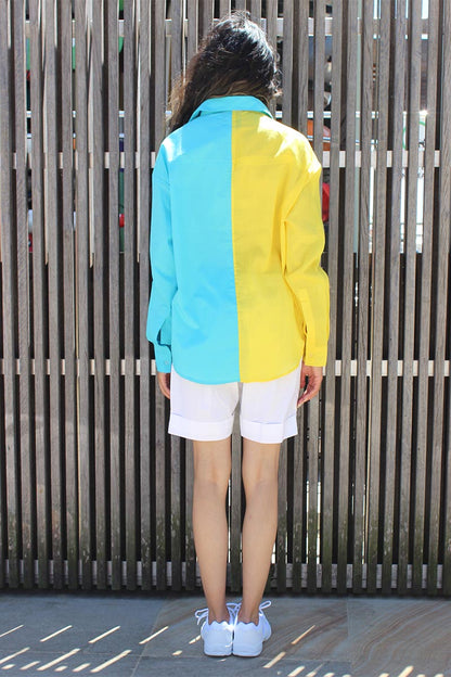 The easy summer shirt that is striking as it is bold in its approach. The oversized 90s referenced Cyrus Shirt is a two toned shirt in Cotton with a shirt collar and cuffed sleeves. In bright tones perfect for a sunny side day, the shirt has black and white trims that give it an extra edge and detail that you might not find somewhere else. Devil surely is in the details. A front button down and style it with Bliss shorts or pants for an easy statement look.