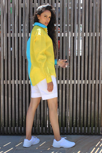 The easy summer shirt that is striking as it is bold in its approach. The oversized 90s referenced Cyrus Shirt is a two toned shirt in Cotton with a shirt collar and cuffed sleeves. In bright tones perfect for a sunny side day, the shirt has black and white trims that give it an extra edge and detail that you might not find somewhere else. Devil surely is in the details. A front button down and style it with Bliss shorts or pants for an easy statement look.